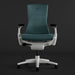 Straight-on view of a blue-green and white Herman Miller X Logitech Embody gaming chair in Galaxy
